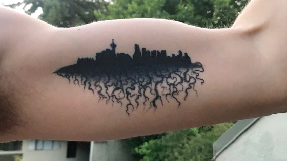 tattoo of the silhouette of vancouver with roots coming out of the bottom