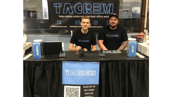 2 co-founders of Tacrem at their table for the okanagan tattoo show, signing artists up for their software